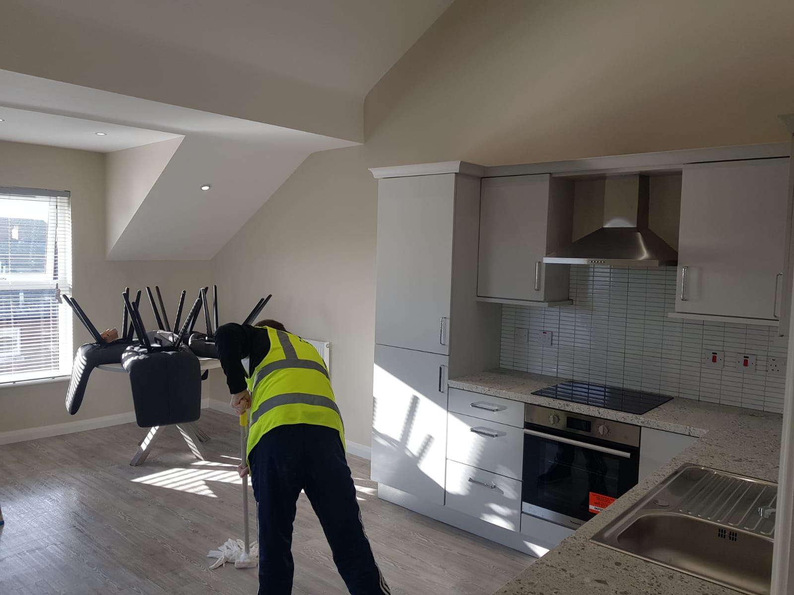 Lady cleaning an open plan studio apartment