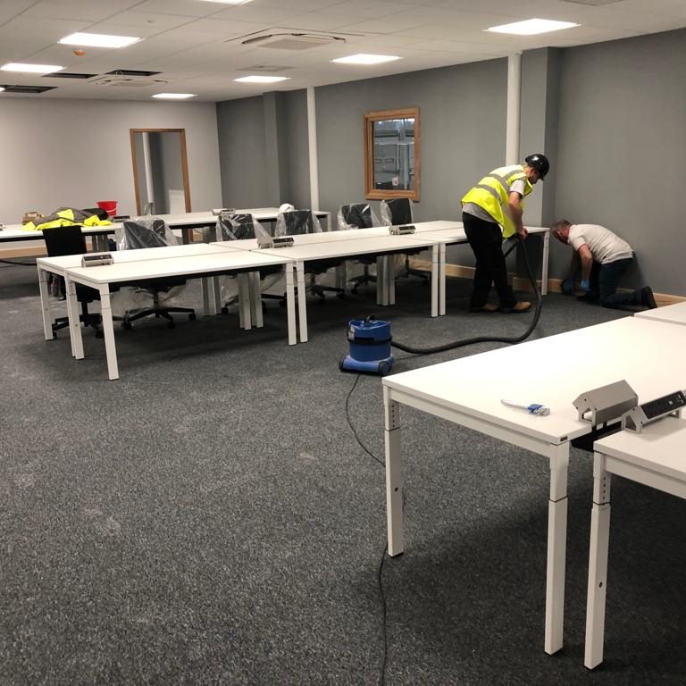 3 men cleaning a large office space