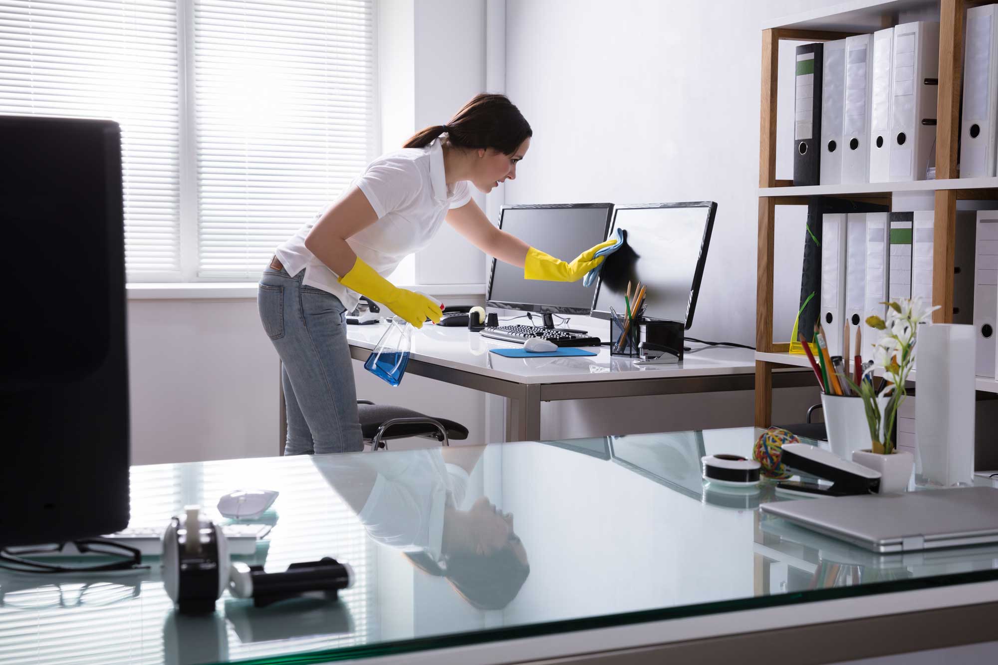 Lady cleaning a small office room
